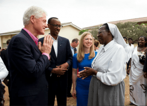 Bill Clinton greeting Sister Epiphanie Mukabaranga, the Headmistress of Rwamagana School of Nursing and Midwifery.  Rwandan President Kagame and Chelsea Clinton look on. 